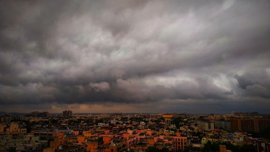 Dark thunderstorm clouds over Gujarat landscape signaling heavy rain forecast in Saurashtra, Kutch and North Gujarat