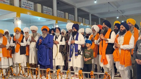 Devotees and Nihang Sikhs celebrating Hola Mohalla with nagaras and traditional attire at Anandpur Sahib